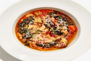 Italian soup with fresh meats, spinach, beans, and croutons