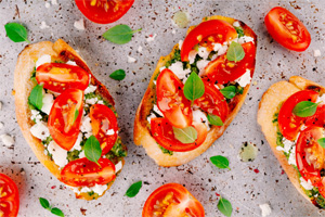 Cripsy bread with cheese, fresh basil and tomatoes