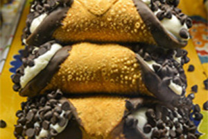 Cannoli shells dipped ends with chocolate and stuffed with ricotta mixture with chocolate chips