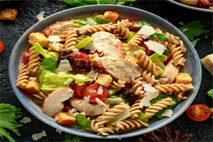 Cork-screw past with fresh romaine lettuce, tomatoes, and mozzarella