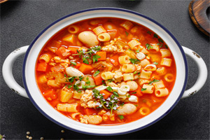 Italian soup with round pasta, vegetables, chesse and parsley