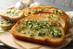 Fresh bread buttered and topped with garlic and parsley