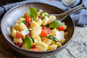 Gnocci noddle served with basil, tomatoes, peppers, and paresan cheese