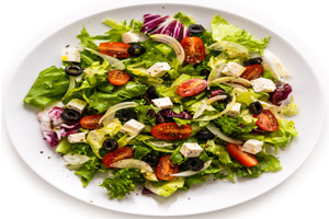 Traditional Italian salad with romaine, tomatoes, red cabbage, black olives, and mozzarella