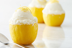 Lemon half stuffed with ladyfingers and vanilla gelato topped with lemon slivers
